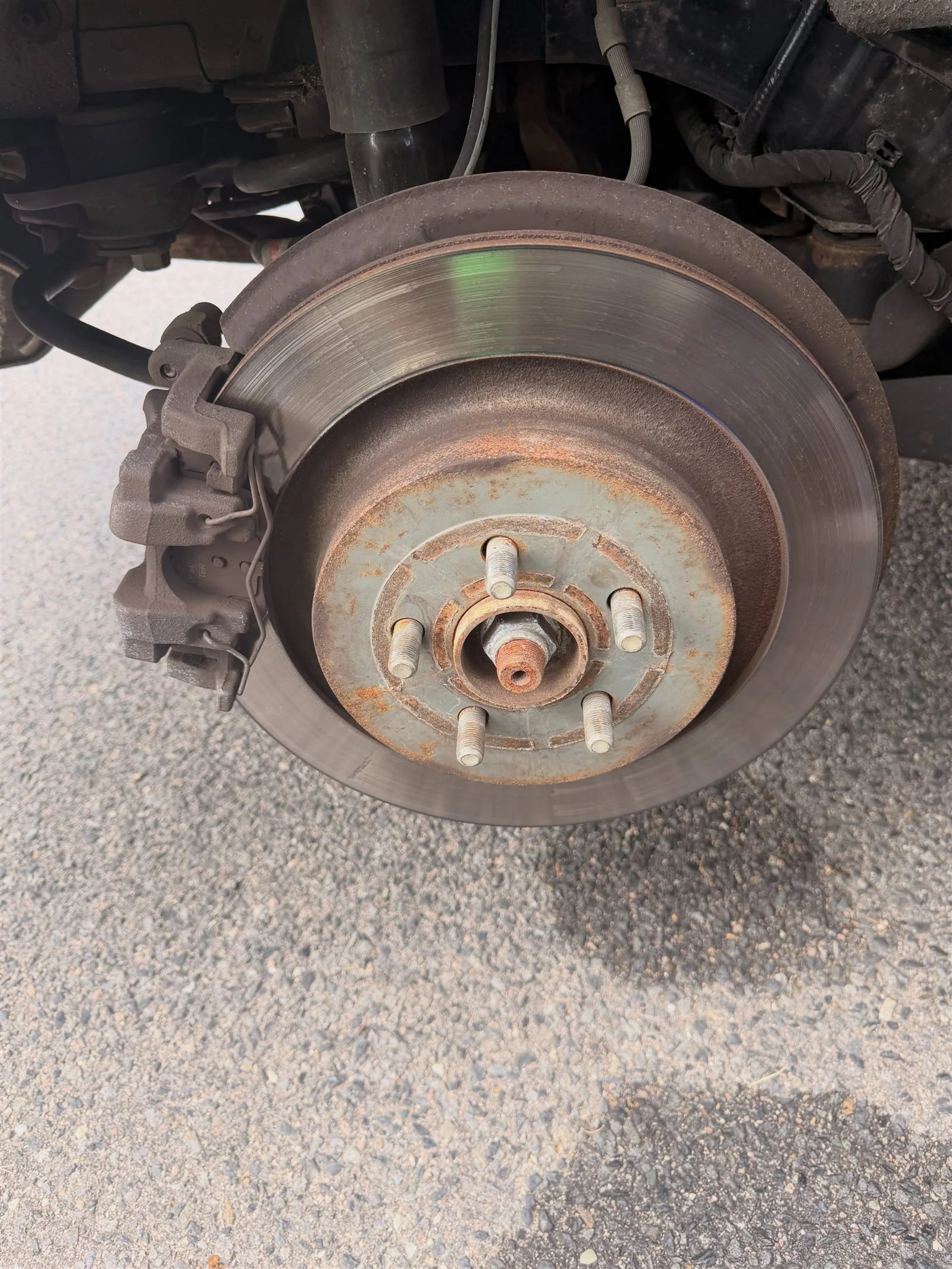 Worn rear brake rotor before service on a 2022 Lincoln Nautilus
