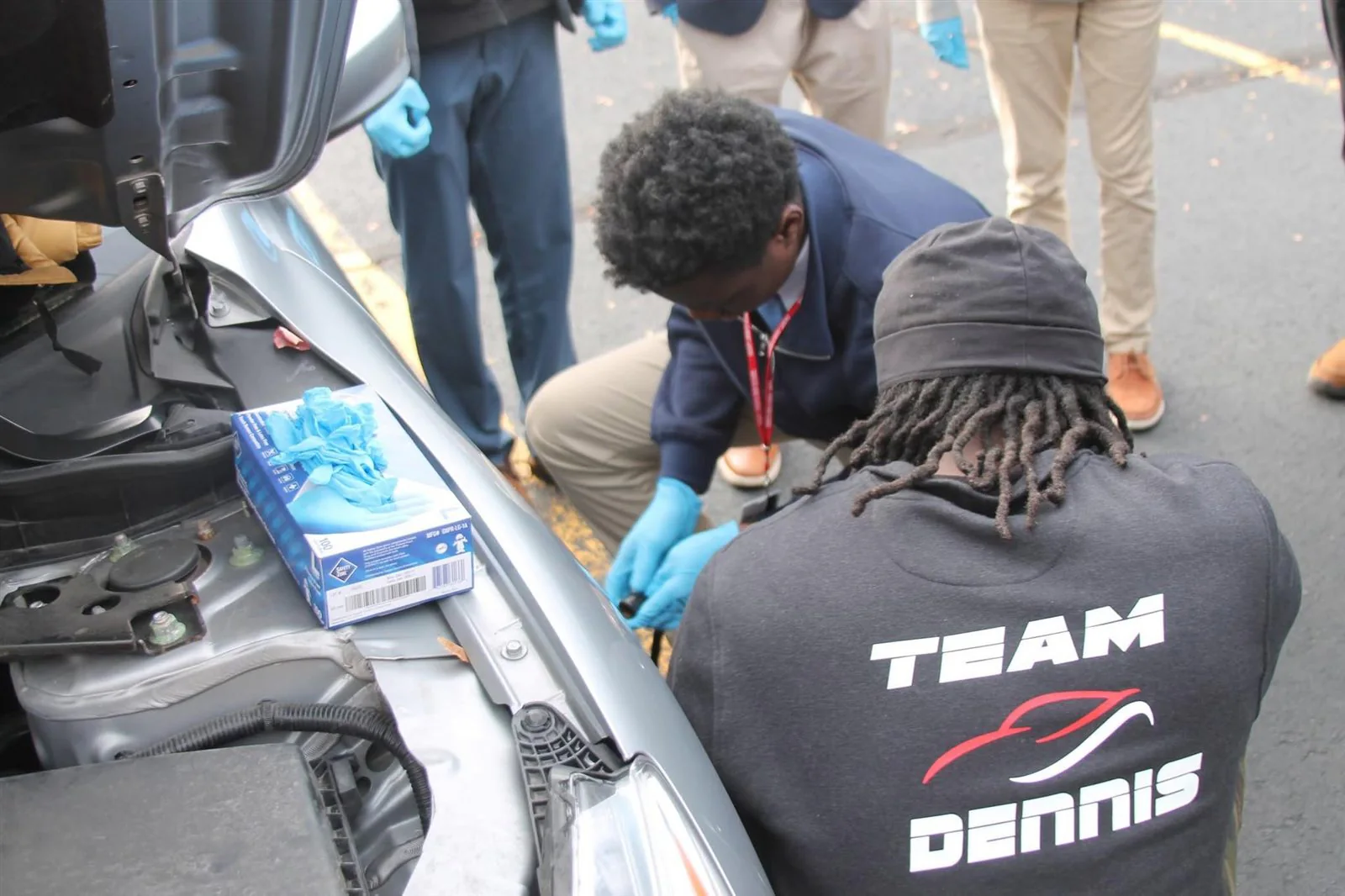Owner-mechanic Terrance Dennis working on a vehicle in Dennis Auto Repair apparel