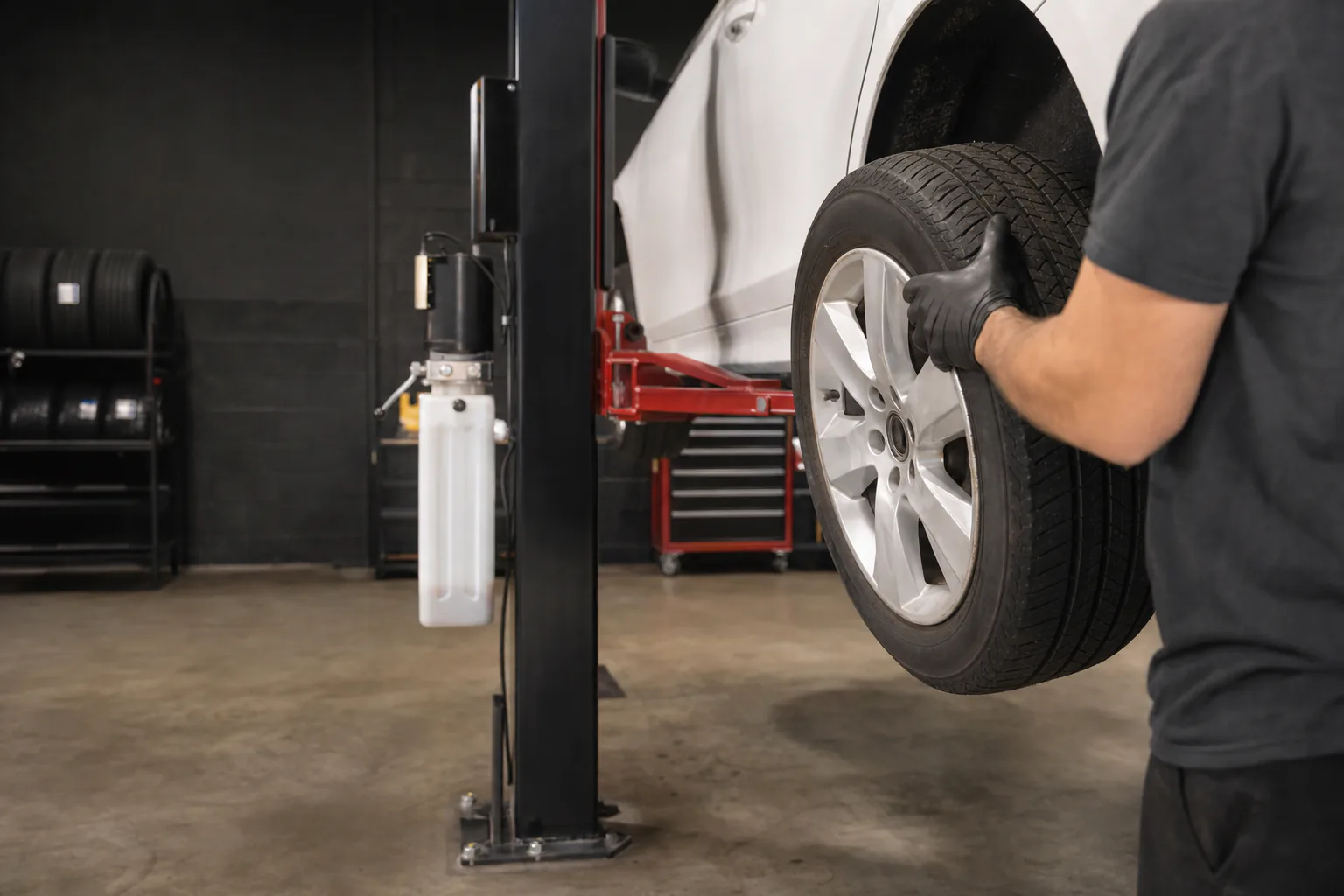 Mechanic removing a wheel during a tire rotation in Worcester, Massachusetts